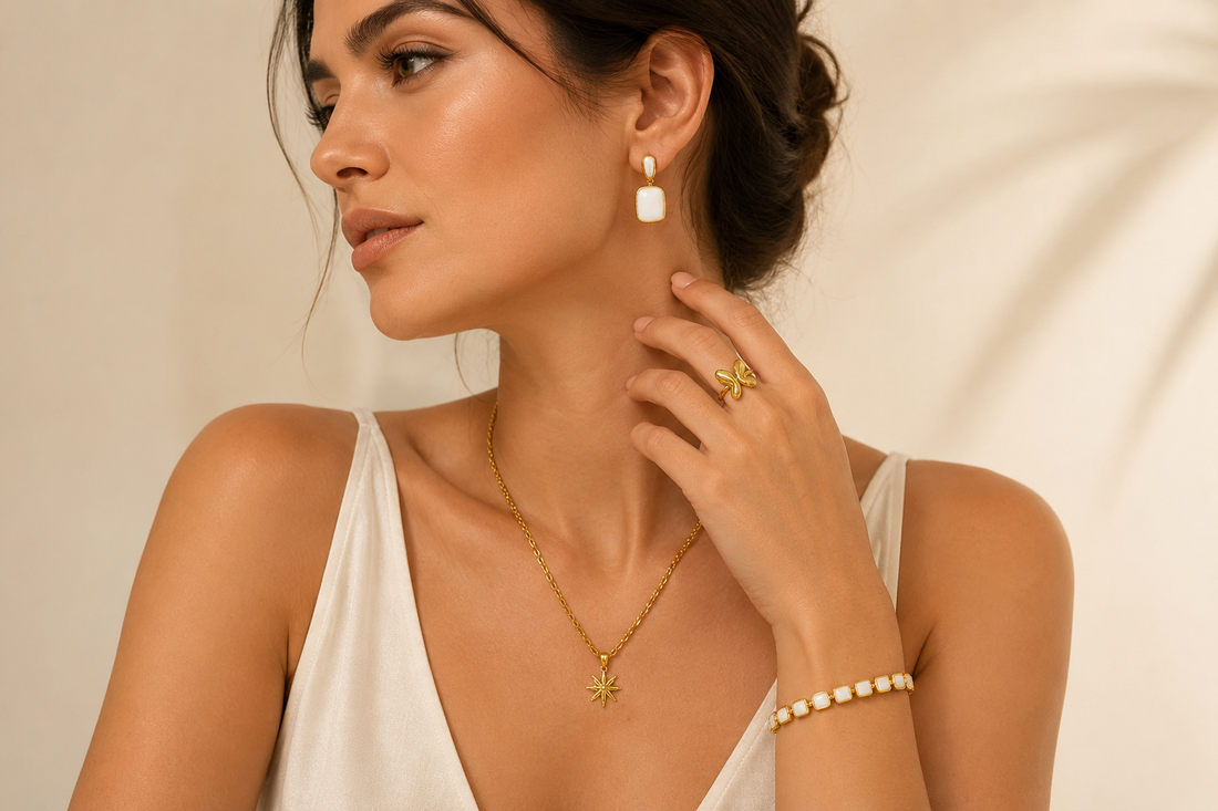 Woman styling layered gold jewelry with necklace, earrings, bracelet and ring for an elegant everyday look